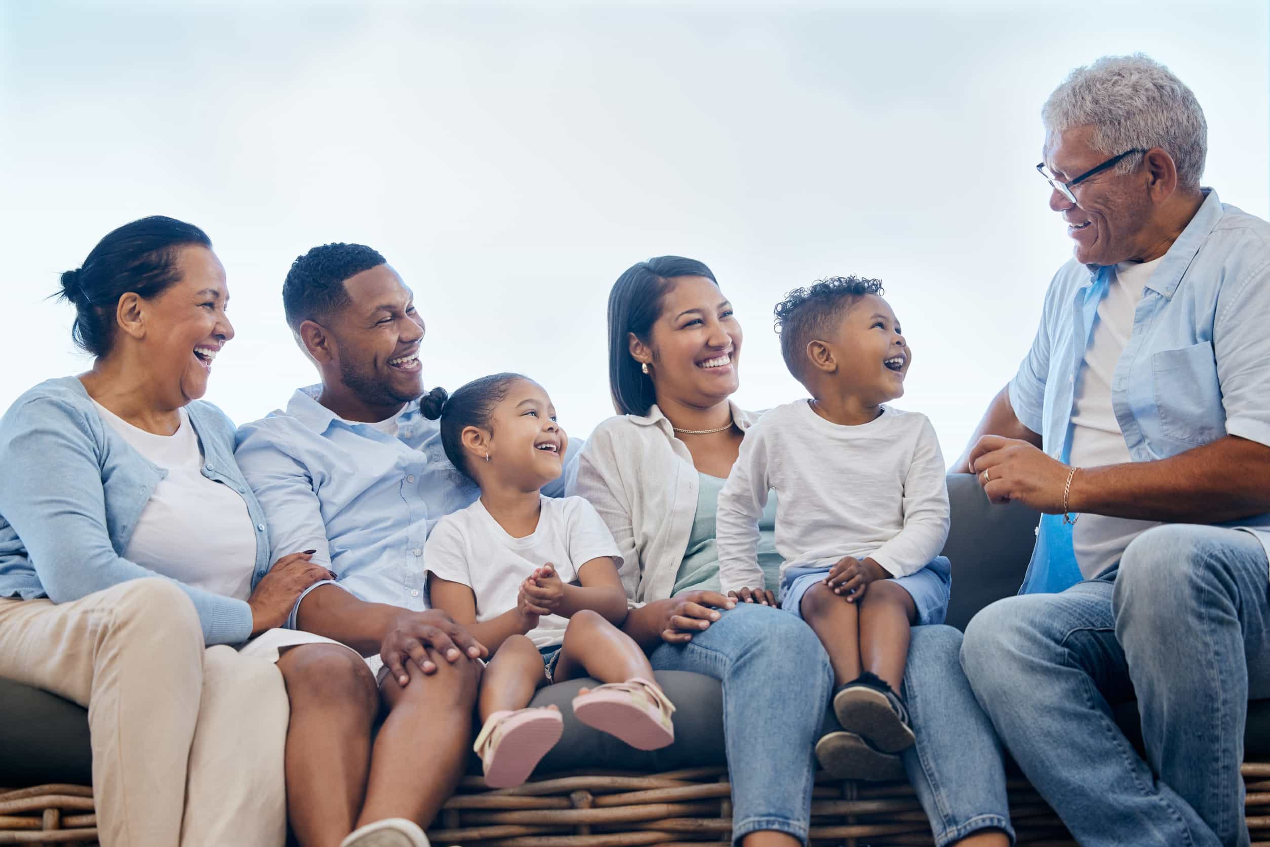 A multigenerational family relaxing together in their backyard, from young children to grandparents, illustrating how relocation planning spans every life stage
